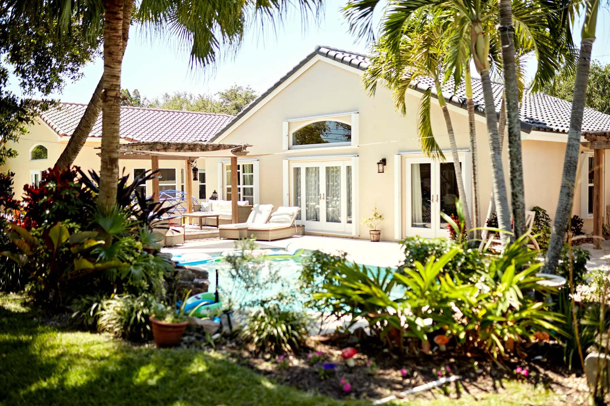 Florida home with an inground pool and tropical landscaping, representing optional home warranty pool coverage.