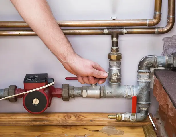 A person repairing plumbing issue.