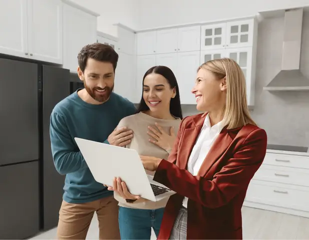 A real estate agent showing homeowners the benefit of an APHW home warranty.