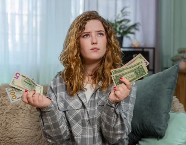 A homeowner sitting with cash, looking for a way to effectively budget.