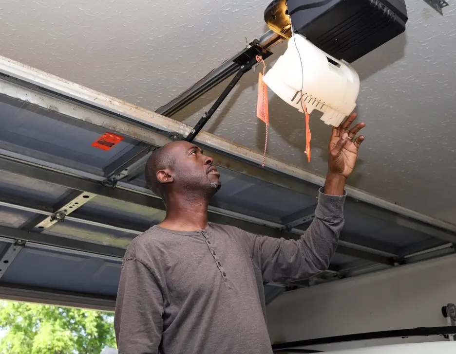 Man checking the central part of the garage door.