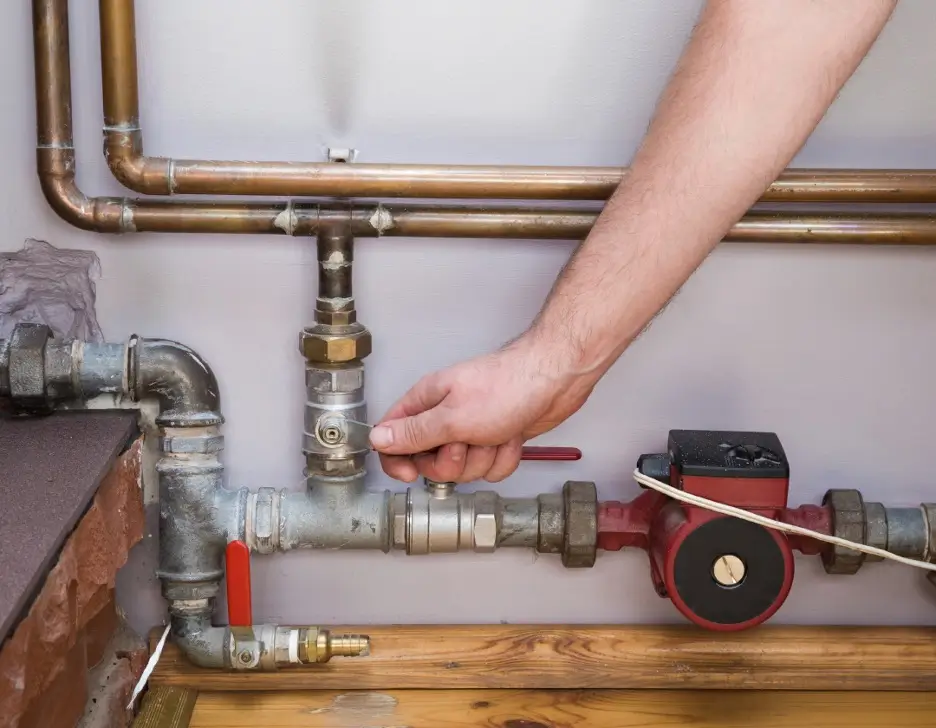 A hand repairing home plumbing.