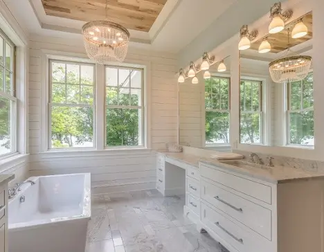 A beautiful, white bathroom illuminated by golden light.