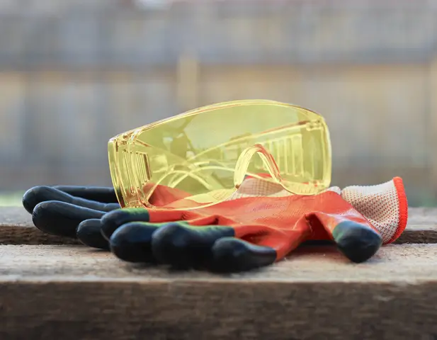 A set of work gloves and safety glasses.