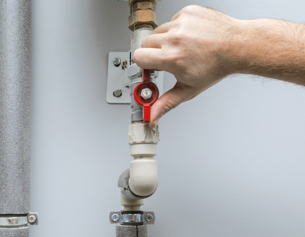 Hand turning off water supply.
