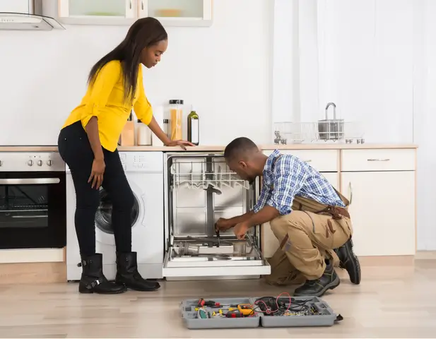 A professional repairing a dishwasher.